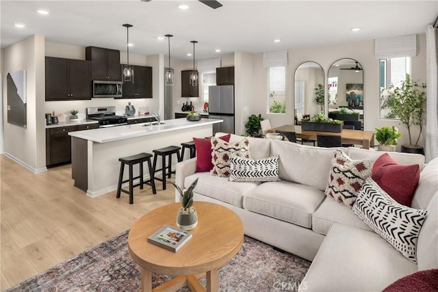 living room with sink and light hardwood / wood-style flooring