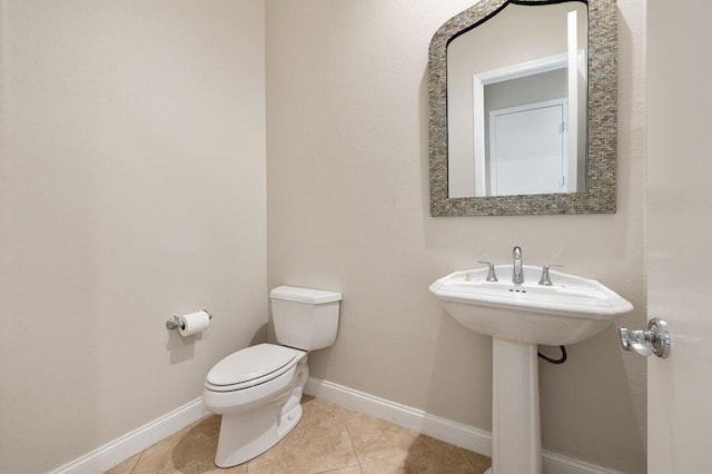 bathroom featuring tile patterned floors, toilet, and sink