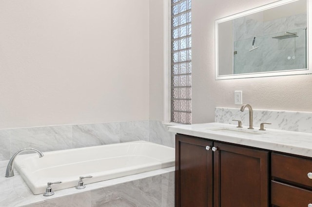 bathroom with vanity and separate shower and tub