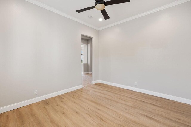 spare room with crown molding, ceiling fan, and light hardwood / wood-style flooring