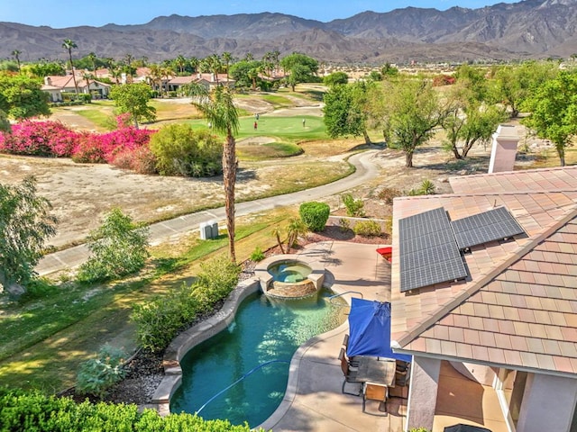 view of swimming pool with a mountain view and an in ground hot tub