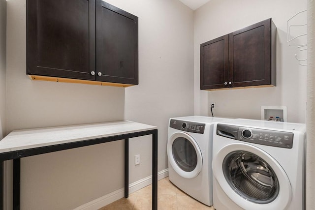 clothes washing area with separate washer and dryer, cabinets, and light tile patterned flooring