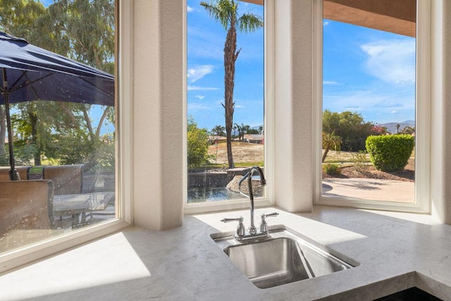 kitchen featuring a water view and sink