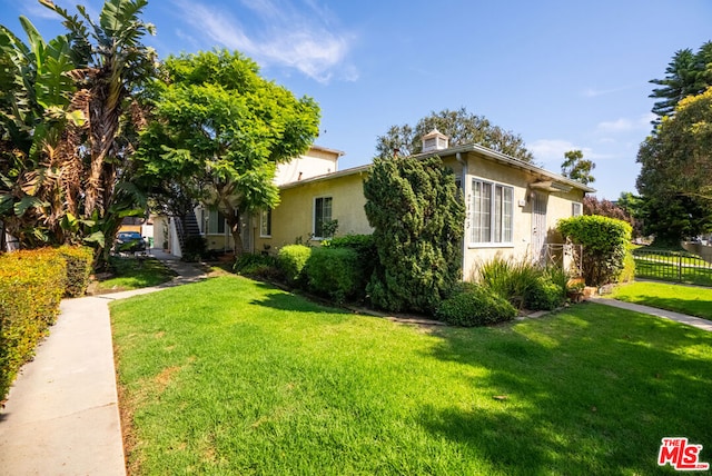 view of property exterior with a lawn