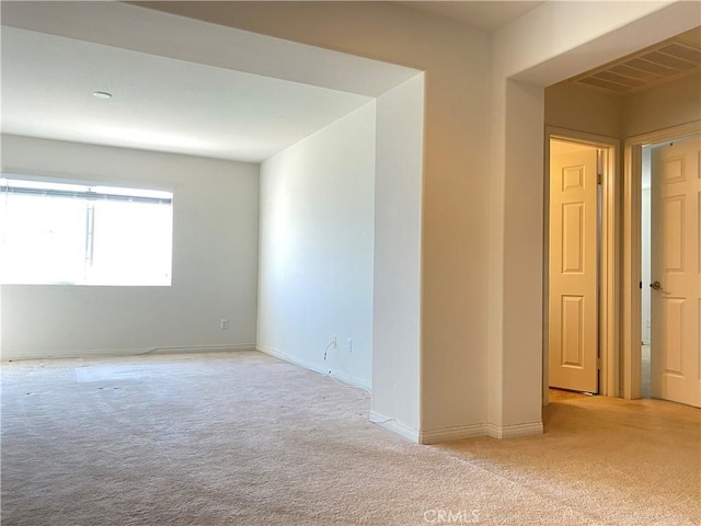 empty room featuring light carpet