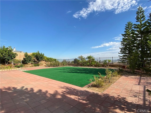 view of pool with a patio area and a yard