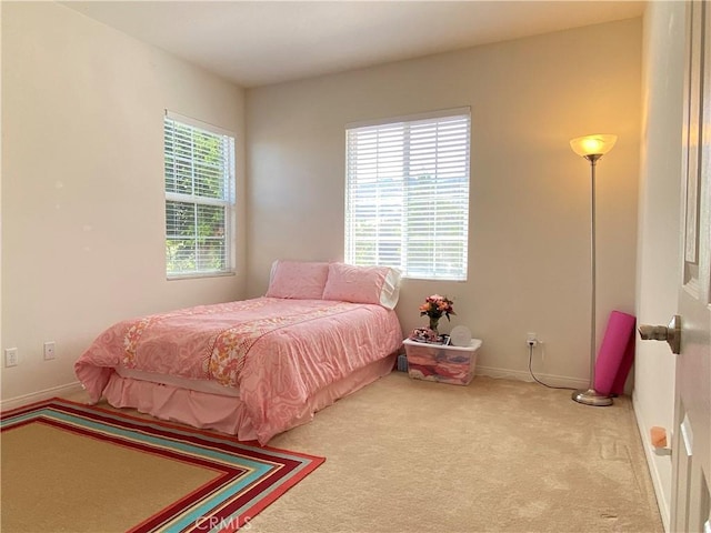 carpeted bedroom with multiple windows