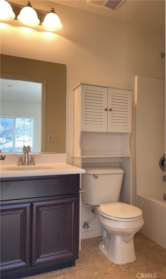 full bathroom featuring tile patterned flooring, shower / tub combination, vanity, and toilet