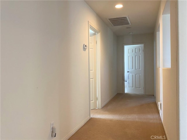 hallway with light colored carpet