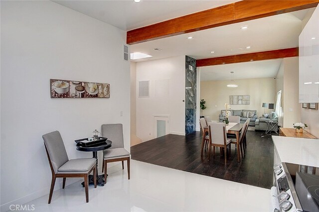 dining room with beamed ceiling and hardwood / wood-style floors