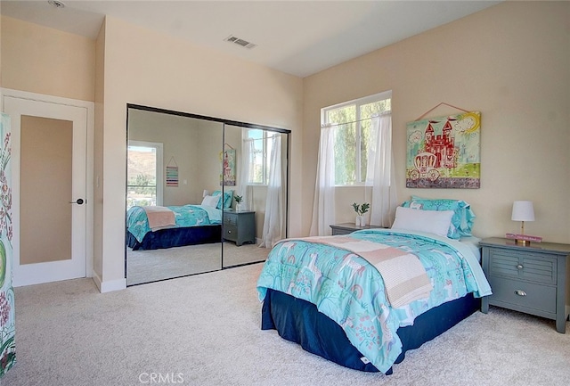 carpeted bedroom featuring a closet