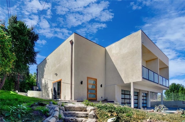 rear view of property with a balcony