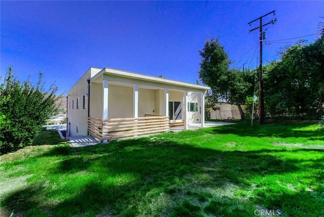 rear view of house featuring a lawn