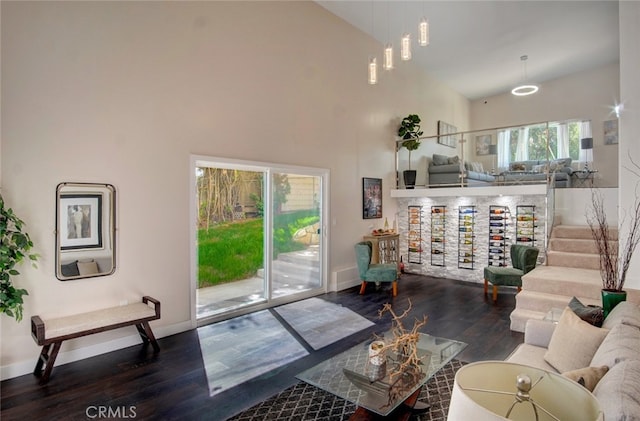 living room featuring high vaulted ceiling and hardwood / wood-style flooring