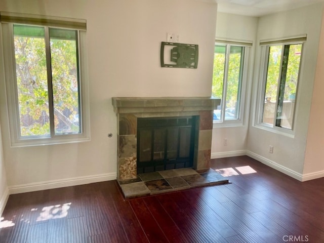 unfurnished living room with a fireplace and dark hardwood / wood-style floors