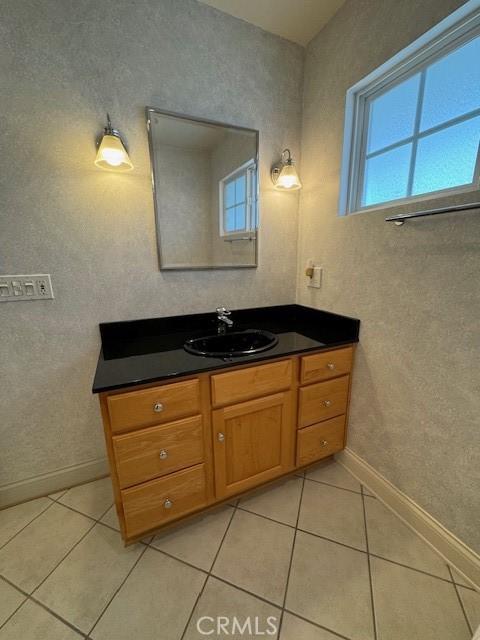 bathroom featuring tile patterned flooring and vanity