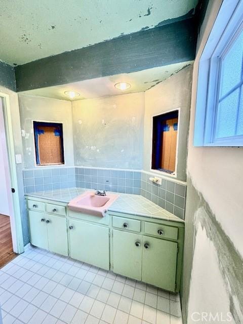 bathroom featuring vanity, tasteful backsplash, and tile patterned floors