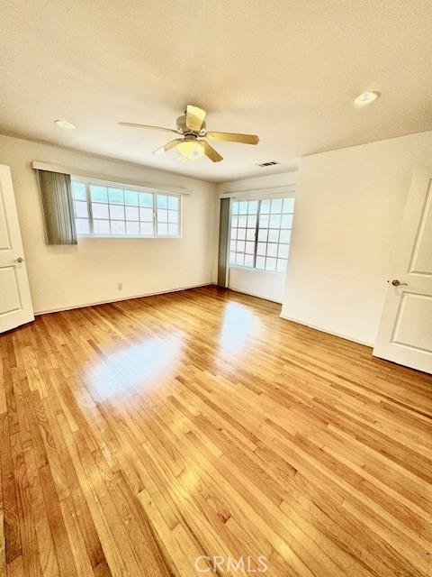 spare room with light hardwood / wood-style flooring and ceiling fan