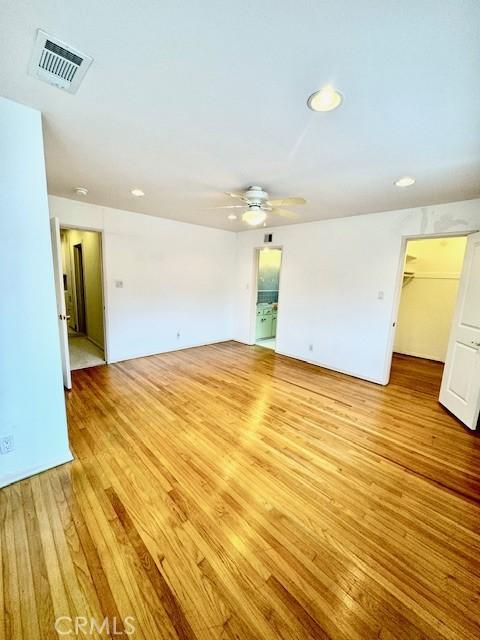 empty room featuring ceiling fan and light wood-type flooring