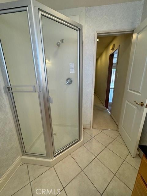 bathroom with tile patterned flooring and an enclosed shower