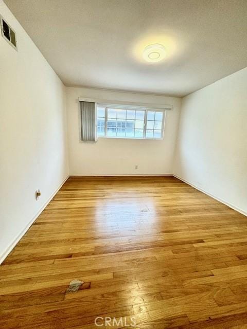 empty room with light hardwood / wood-style flooring