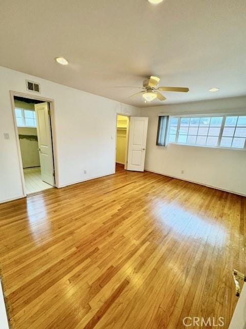 unfurnished bedroom featuring light wood-type flooring and ceiling fan