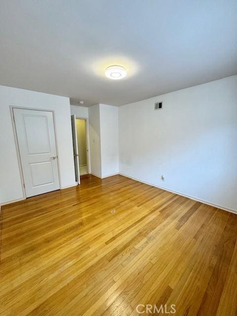 empty room with light hardwood / wood-style floors