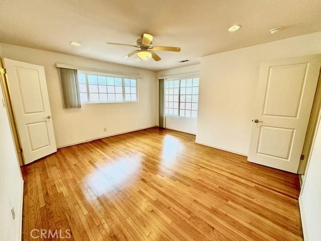 unfurnished room with light hardwood / wood-style floors and ceiling fan