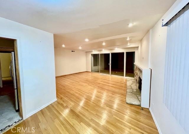 unfurnished living room with light hardwood / wood-style flooring