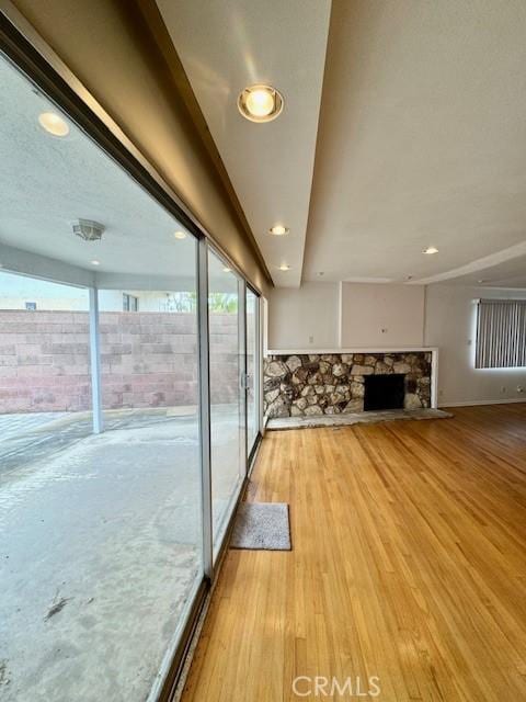 unfurnished living room featuring a fireplace and light hardwood / wood-style floors