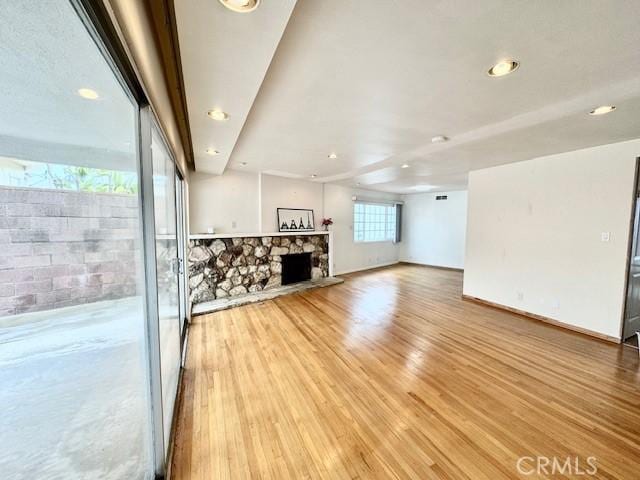 unfurnished living room with light hardwood / wood-style floors and a fireplace