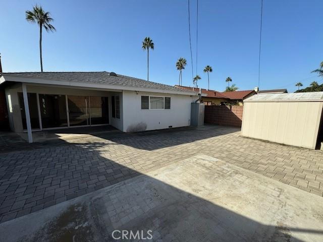 back of property with a patio