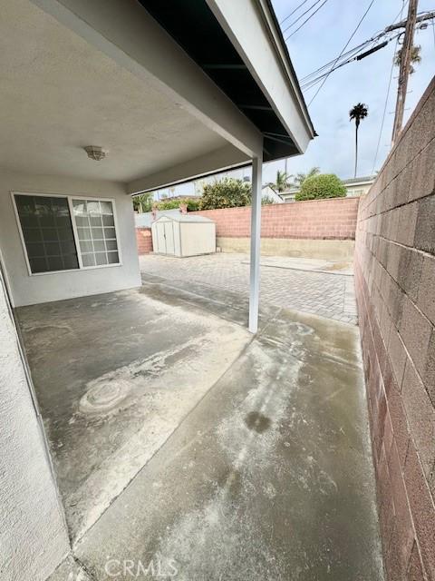 view of patio / terrace with a shed