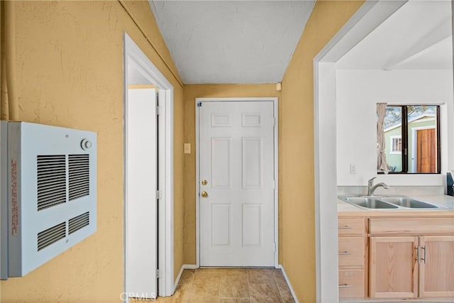 kitchen featuring sink and light brown cabinets