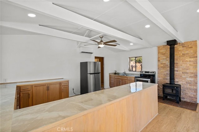 kitchen with light hardwood / wood-style floors, vaulted ceiling with beams, kitchen peninsula, a wall mounted air conditioner, and stainless steel appliances