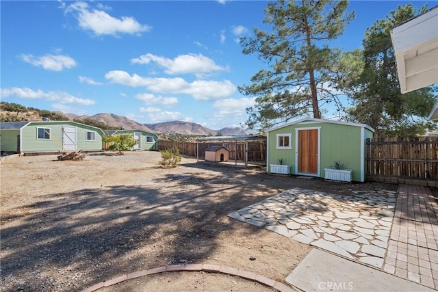 view of yard with a mountain view and a storage shed