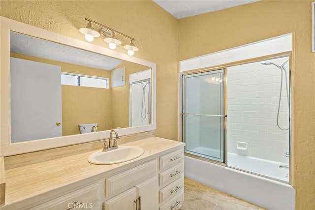 full bathroom featuring toilet, vanity, tile patterned floors, and combined bath / shower with glass door