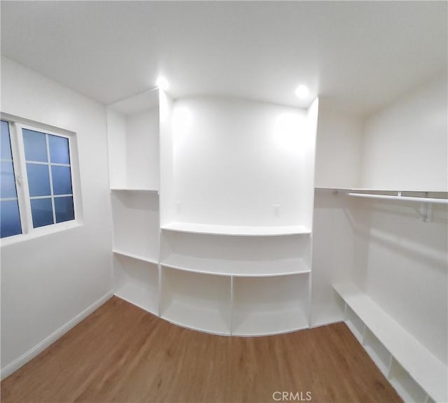 spacious closet featuring hardwood / wood-style flooring