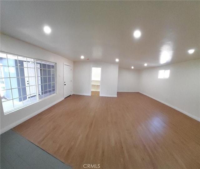 unfurnished room with plenty of natural light and hardwood / wood-style floors