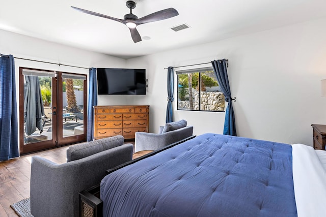 bedroom featuring french doors, access to outside, hardwood / wood-style flooring, and ceiling fan