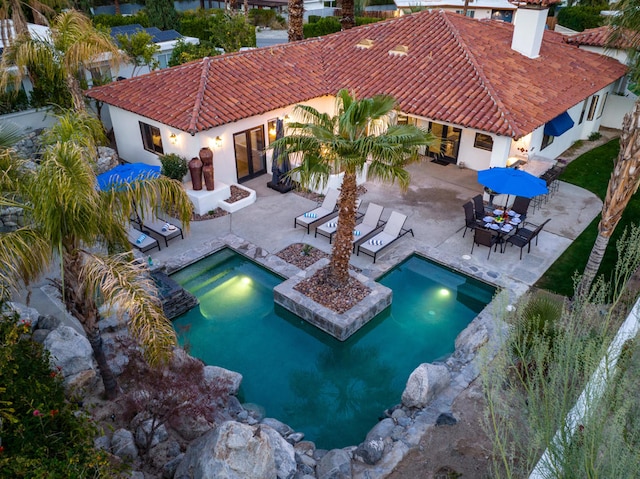 view of pool with a patio and a hot tub