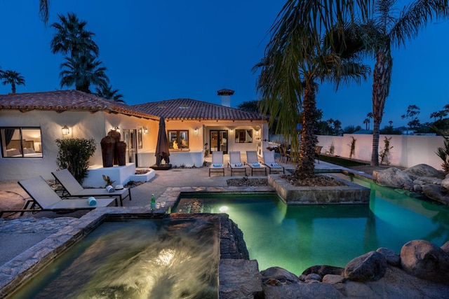 view of pool featuring a jacuzzi and a patio area