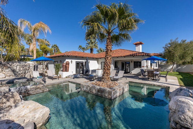 back of house with a patio