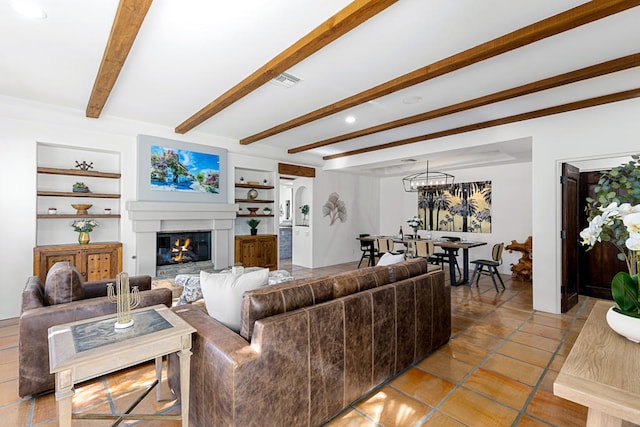 living room featuring beam ceiling, light tile patterned floors, built in features, and a chandelier