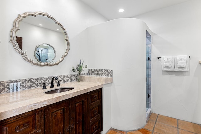 bathroom featuring walk in shower, vanity, and tile patterned flooring