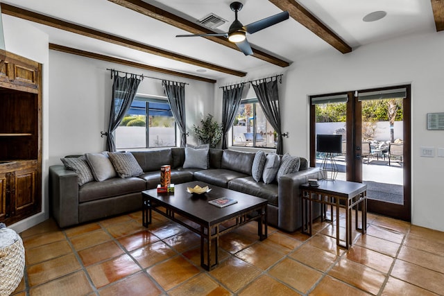 tiled living room with beam ceiling, a wealth of natural light, and ceiling fan