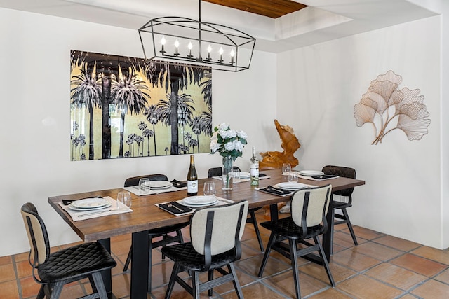 dining area featuring tile patterned floors and a chandelier