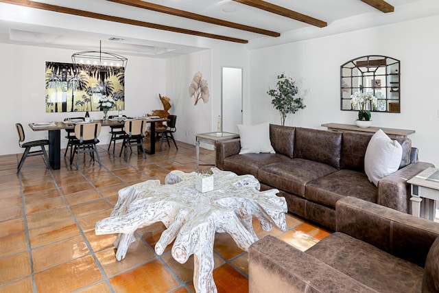 tiled living room featuring beam ceiling and a notable chandelier