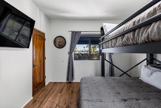 unfurnished bedroom with dark wood-type flooring