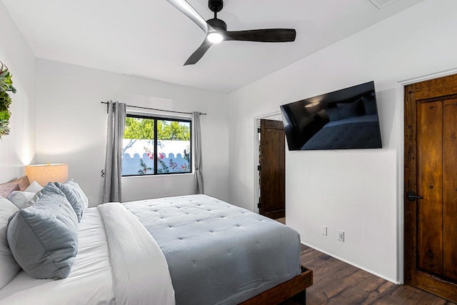 bedroom with dark wood-type flooring and ceiling fan